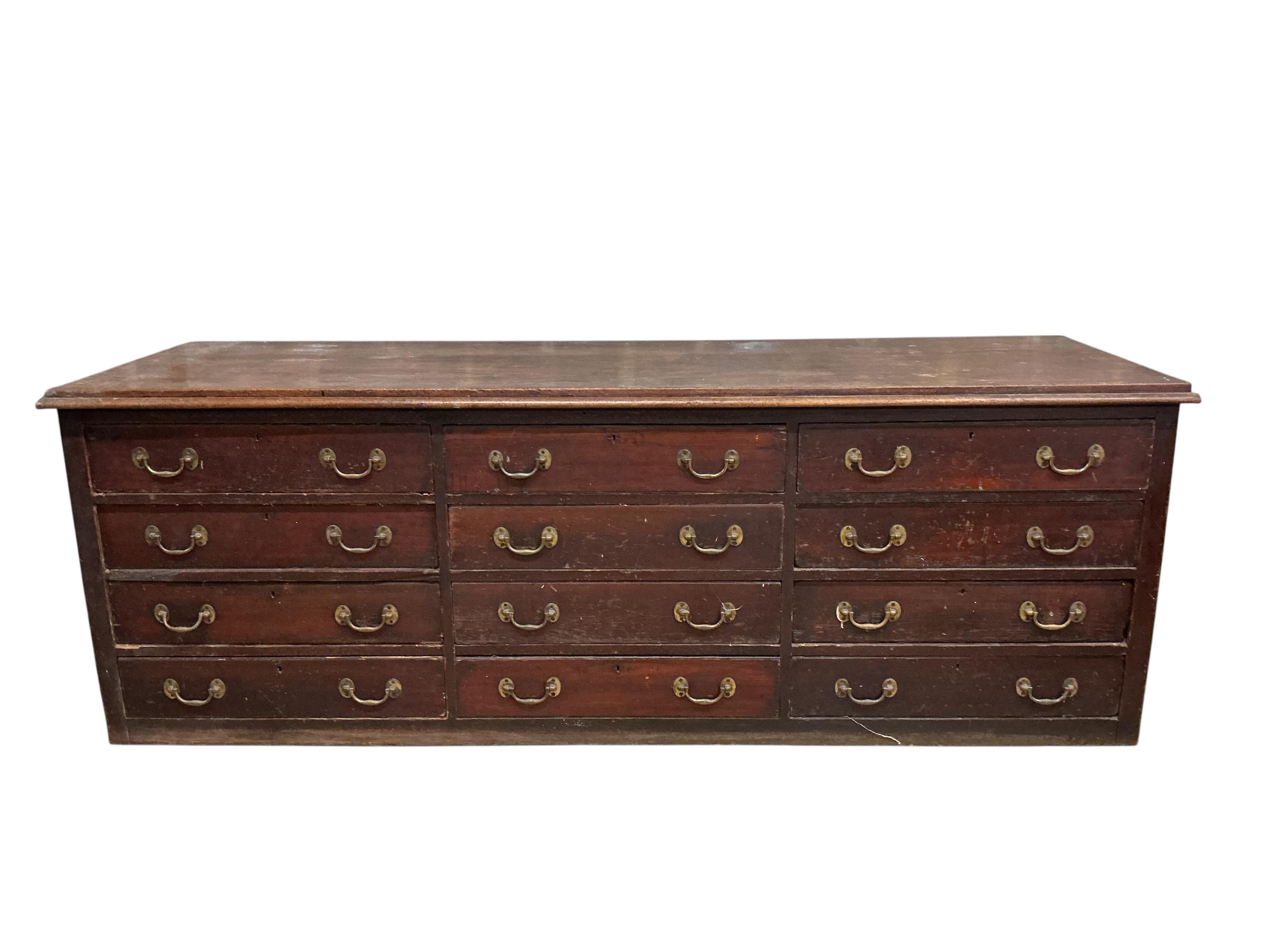A Victorian mahogany twelve drawer shop counter, width 252cm, depth 78cm, height 87cm